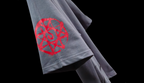 Gray t-shirt with red logo on a black background with 'Philosopher's Stone' text.